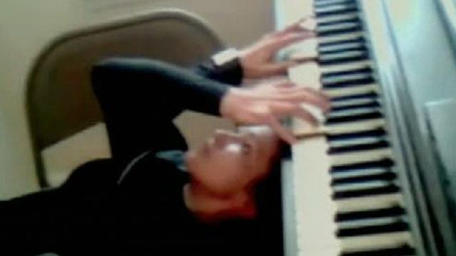 Woman Plays Bach on Piano Upside Down