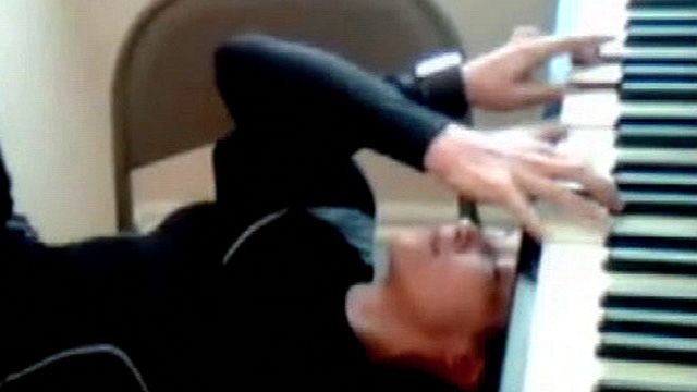 Woman Plays Piano Upside Down