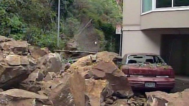 Rockslide buries car, condo complex evacuated
