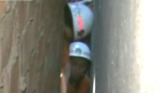 Workers Rush to Rescue Trapped Girl