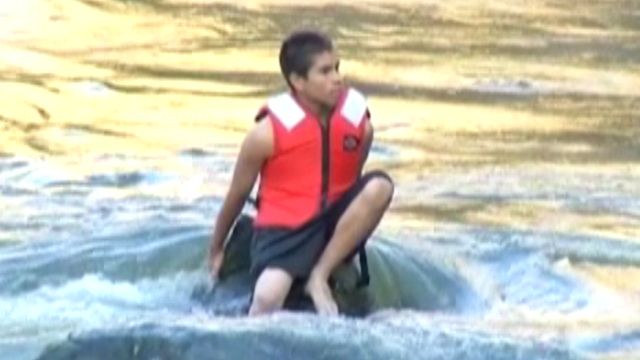 Trapped teen rescued from rushing water
