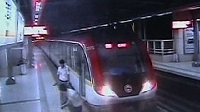 Man Films Jump Onto Train Tracks