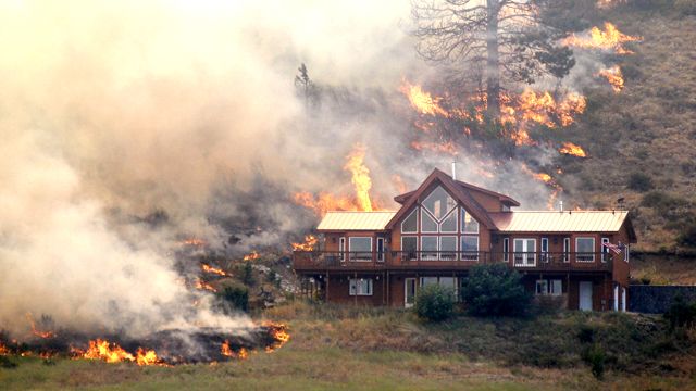 Western wildfires destroy dozens of homes, threaten more