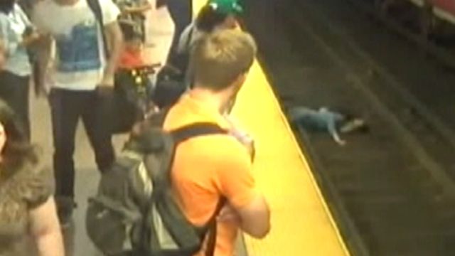 Watch your step! Mom carrying son falls onto train tracks