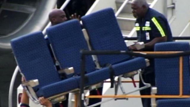 Airline blames spilled drinks, bad clamps for loose seats