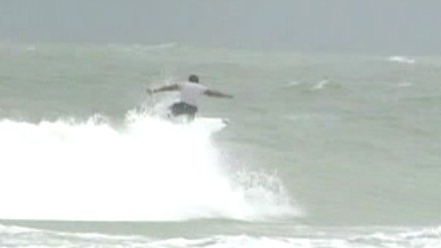 Brave surfers tackle rough waters as hurricane approaches