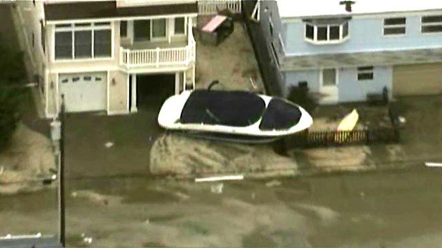 Superstorm Sandy litters New Jersey town with boats, trees