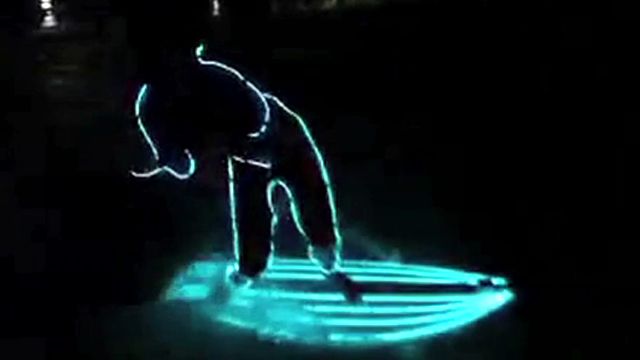 Neon Surfers Hang 10 on Moonlit Waves