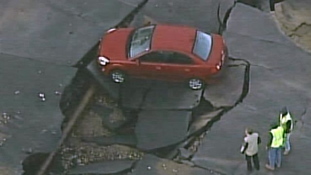 Car Caught in Sinkhole