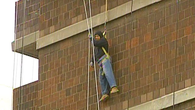Man Dangles from Scaffold Six Stories Above Ground