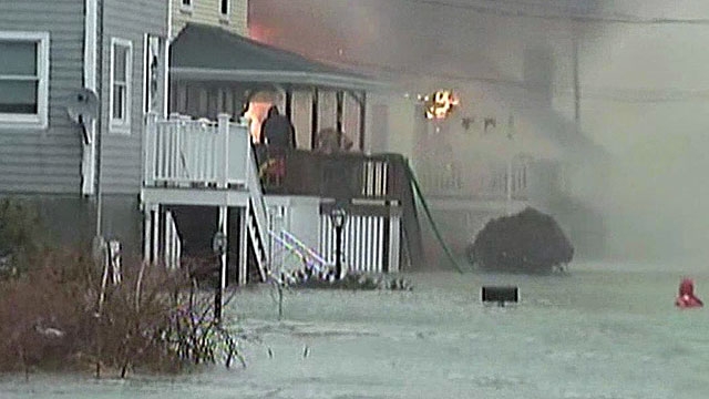 Fire and Ice: Firefighters Battle Blaze in Snowstorm